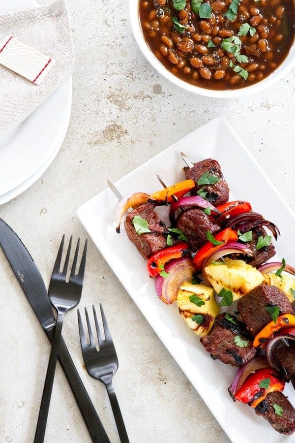 Sweet and Spicy Beef Kebabs are a delicious twist on traditional kebabs. Loaded with bell peppers, red onion, and pineapple - you'll be craving them all summer long! 