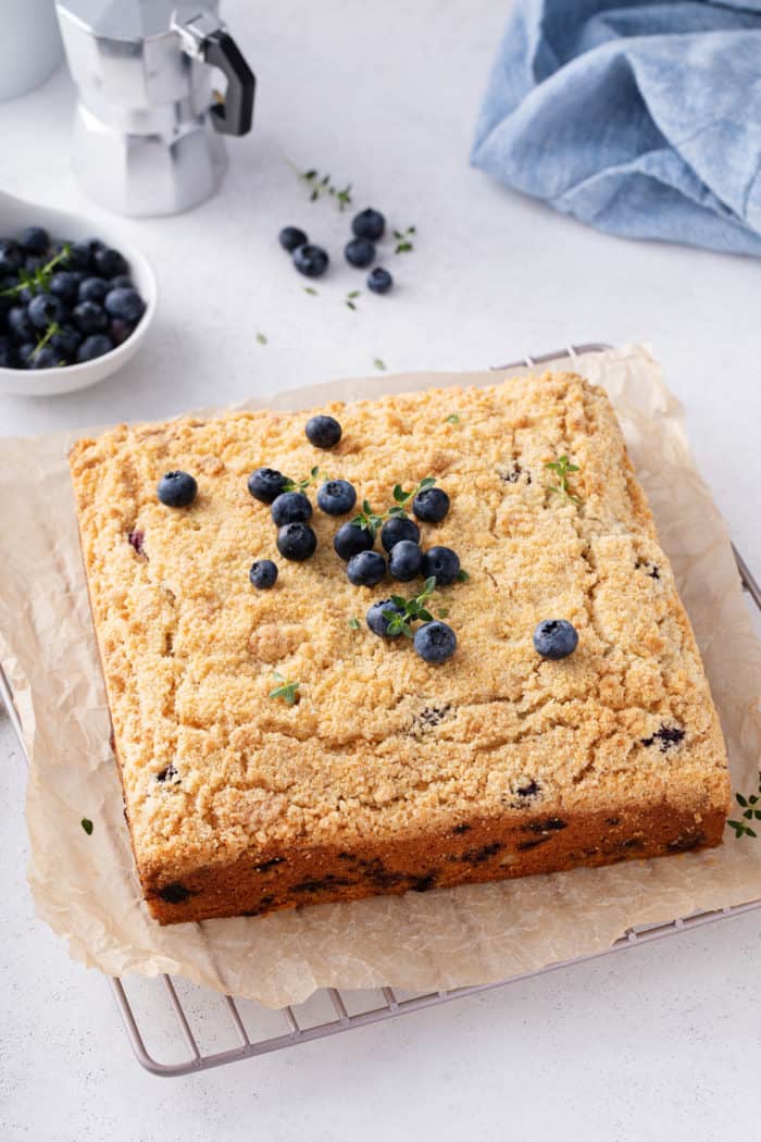 Baked blueberry coffee cake on a wire cooling rack.