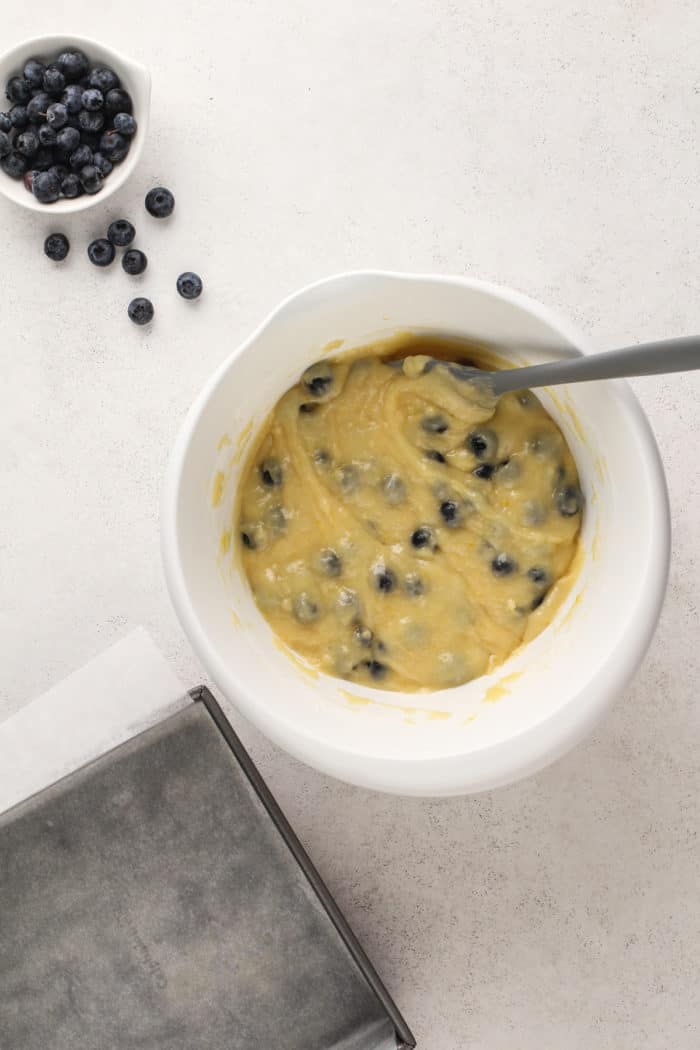 Blueberry coffee cake batter in a white bowl.