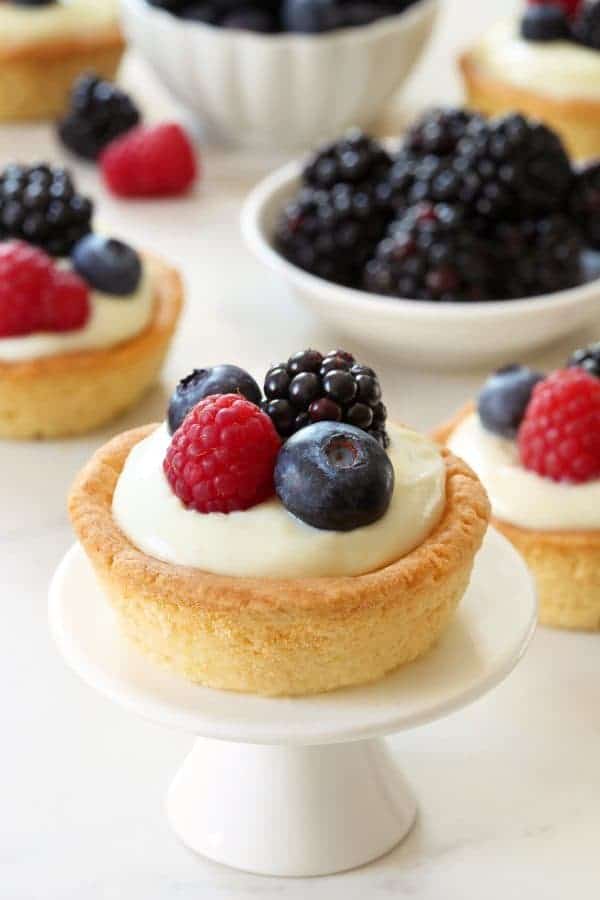 Berry Cookie Cups combine sweet sugar cookies and white chocolate cream cheese filling to create the perfect summer dessert!  Recipe contains gluten-free option.
