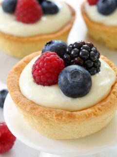 Berry Cookie Cups have a sugar cookie crust and white chocolate cream cheese filling! Top them with fresh berries for the perfect summer dessert. Recipe contains gluten-free option.