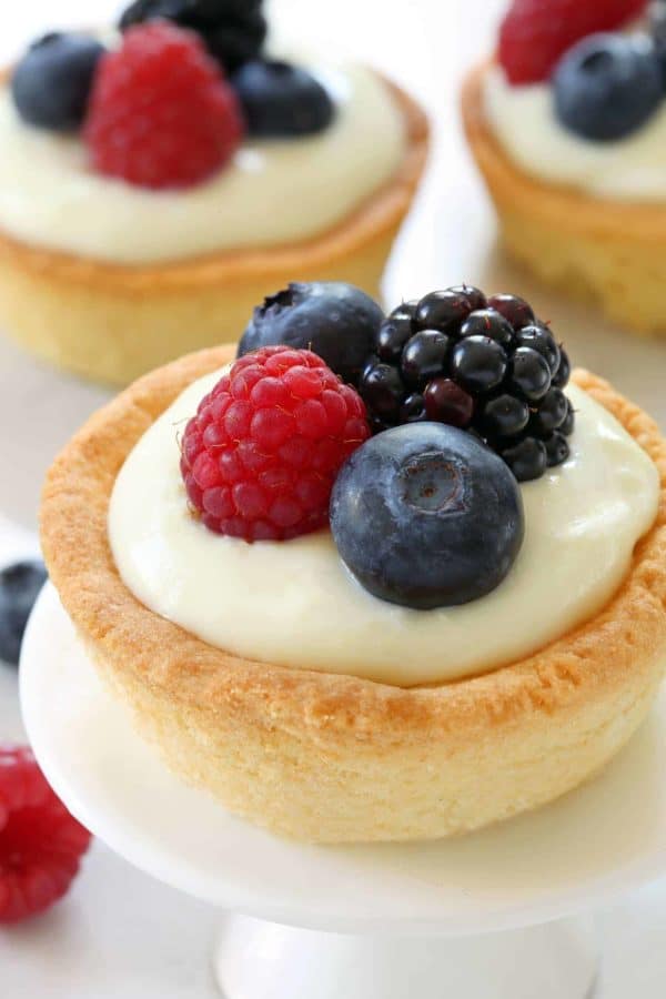 Berry Cookie Cups have a sugar cookie crust and white chocolate cream cheese filling! Top them with fresh berries for the perfect summer dessert. Recipe contains gluten-free option.