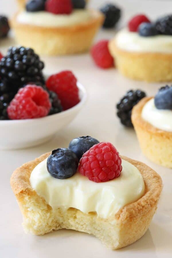 Berry Cookie Cups have a sweet cookie crust and delicious white chocolate cream cheese filling. Fresh, ripe berries make them a delicious dessert for summer. Recipe contains gluten-free option.