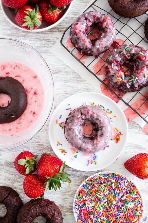 Baked Chocolate Donuts with strawberry frosting are a sweet and enticing breakfast. Grab one on your way to work for a delicious commute!