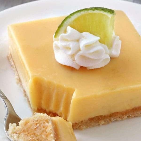 Key Lime Pie Bars are your favorite pie in a delicious bar. Great for a crowd! Recipe has a gluten-free option.