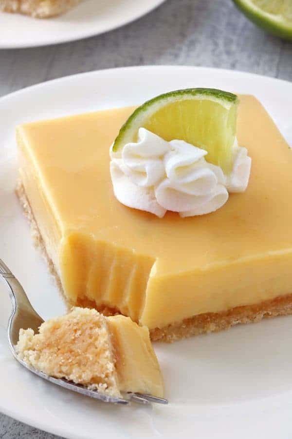 Key Lime Pie Bars are your favorite pie in a delicious bar. Great for a crowd! Recipe has a gluten-free option. 