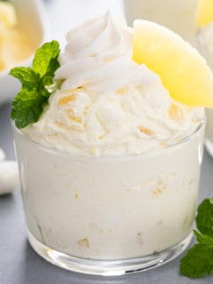 Close up image of pineapple fluff in a glass bowl.