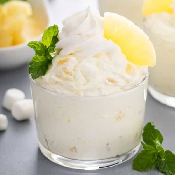 Close up image of pineapple fluff in a glass bowl.
