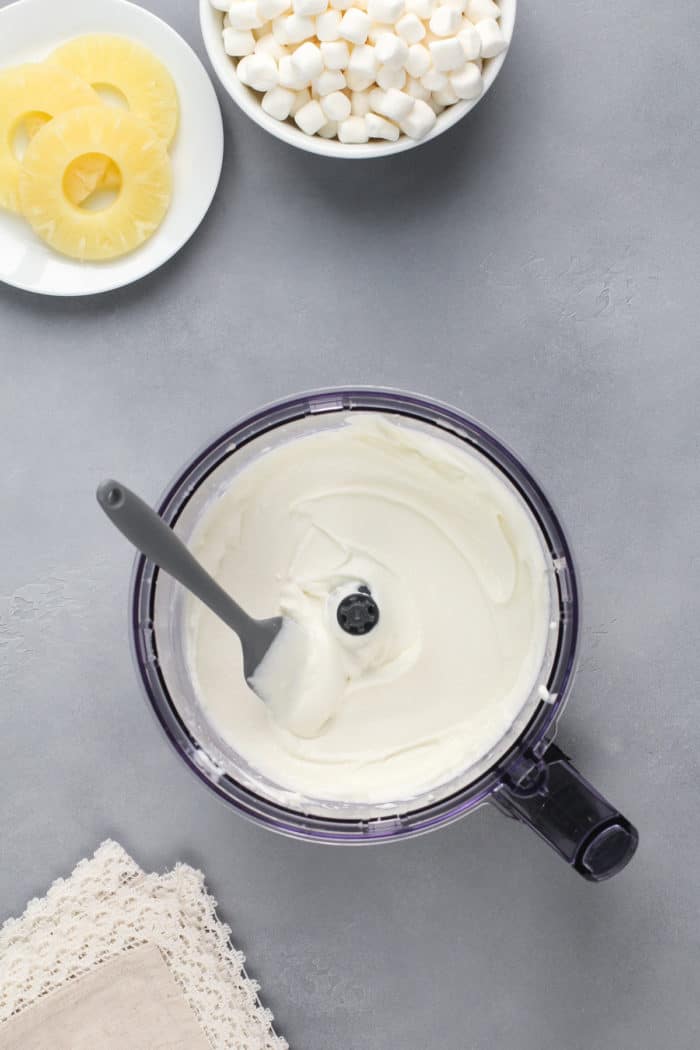 Cottage cheese pureed in the bowl of a food processor.