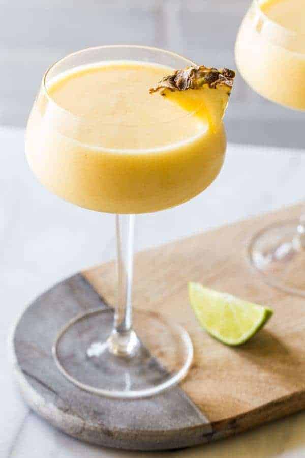 Frozen Pineapple Mango Daiquiris are the ultimate hot weather cocktail: smooth, cold, fruity and not-too-sweet. So amazing for summer. 