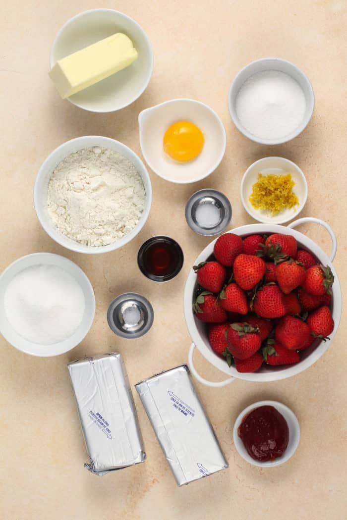 Strawberry tart ingredients arranged on a countertop.