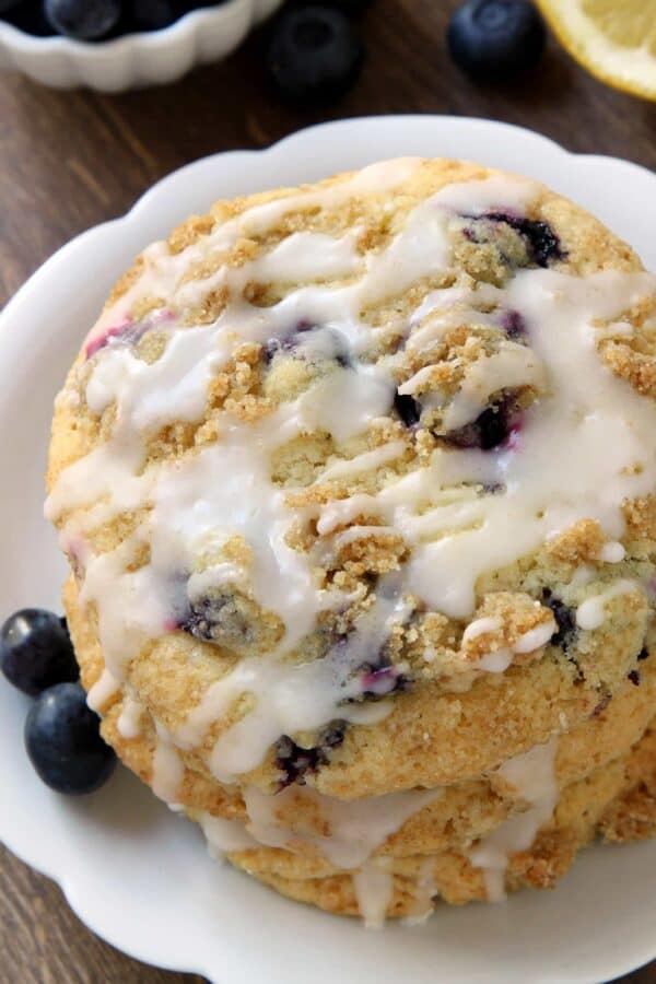 Blueberry Muffin Top Cookies are topped with streusel and a sweet and tart lemon glaze. TThey're loaded with fresh blueberries and perfect for summer entertaining! Recipe contains a gluten-free option.