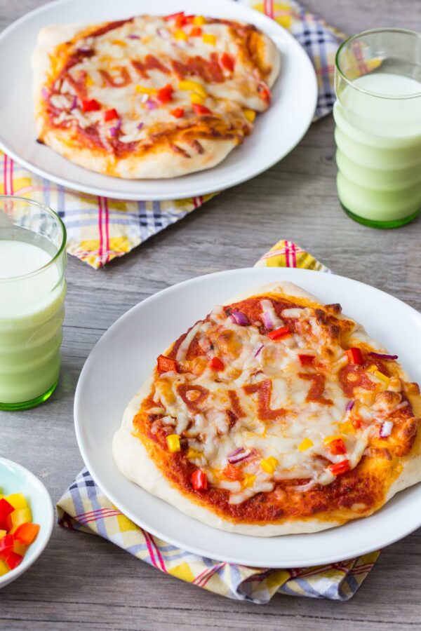 30 Minute Pizza Crust is super fun and easy because there is no need for rising time. Divide the dough into mini crusts so everyone can create their own with their favorite toppings. The perfect after school pizza snack!