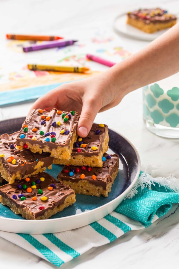 Chocolate Scotcheroos combine peanut butter, crispy rice cereal, and chocolate into one delicious treat. A perfect recipe to make with your kiddos!