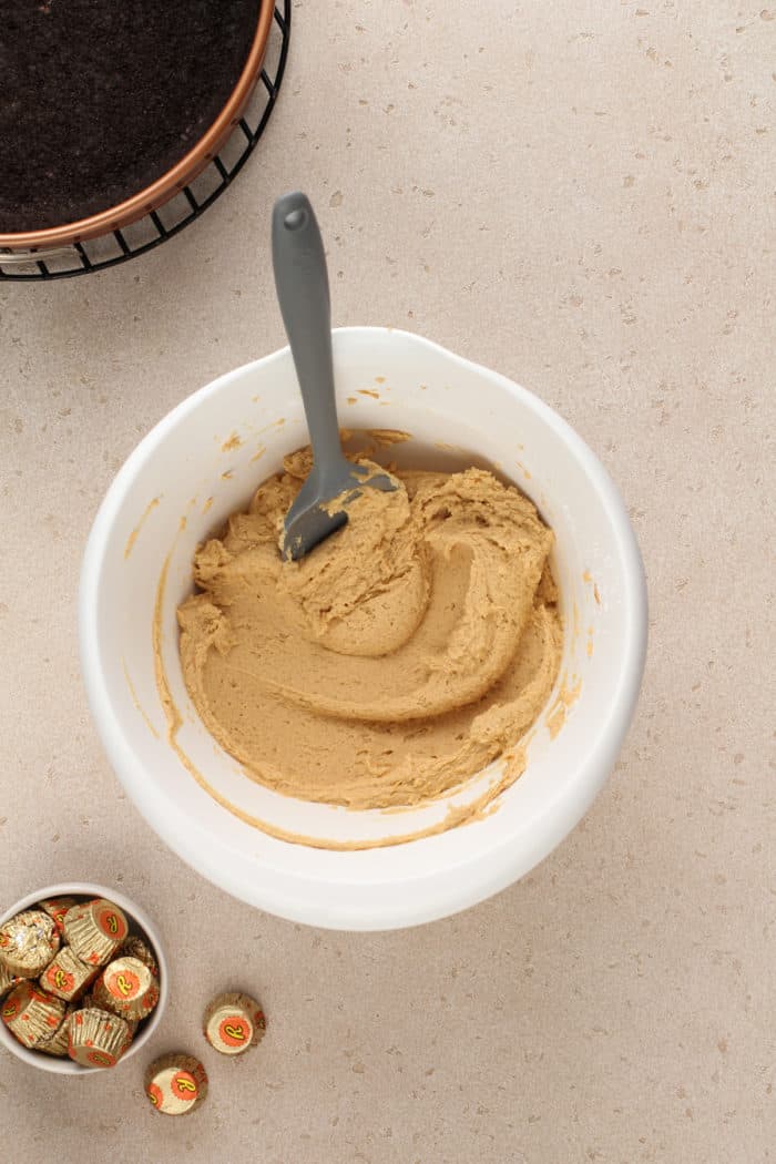 Base for peanut butter pie filling in a white mixing bowl.