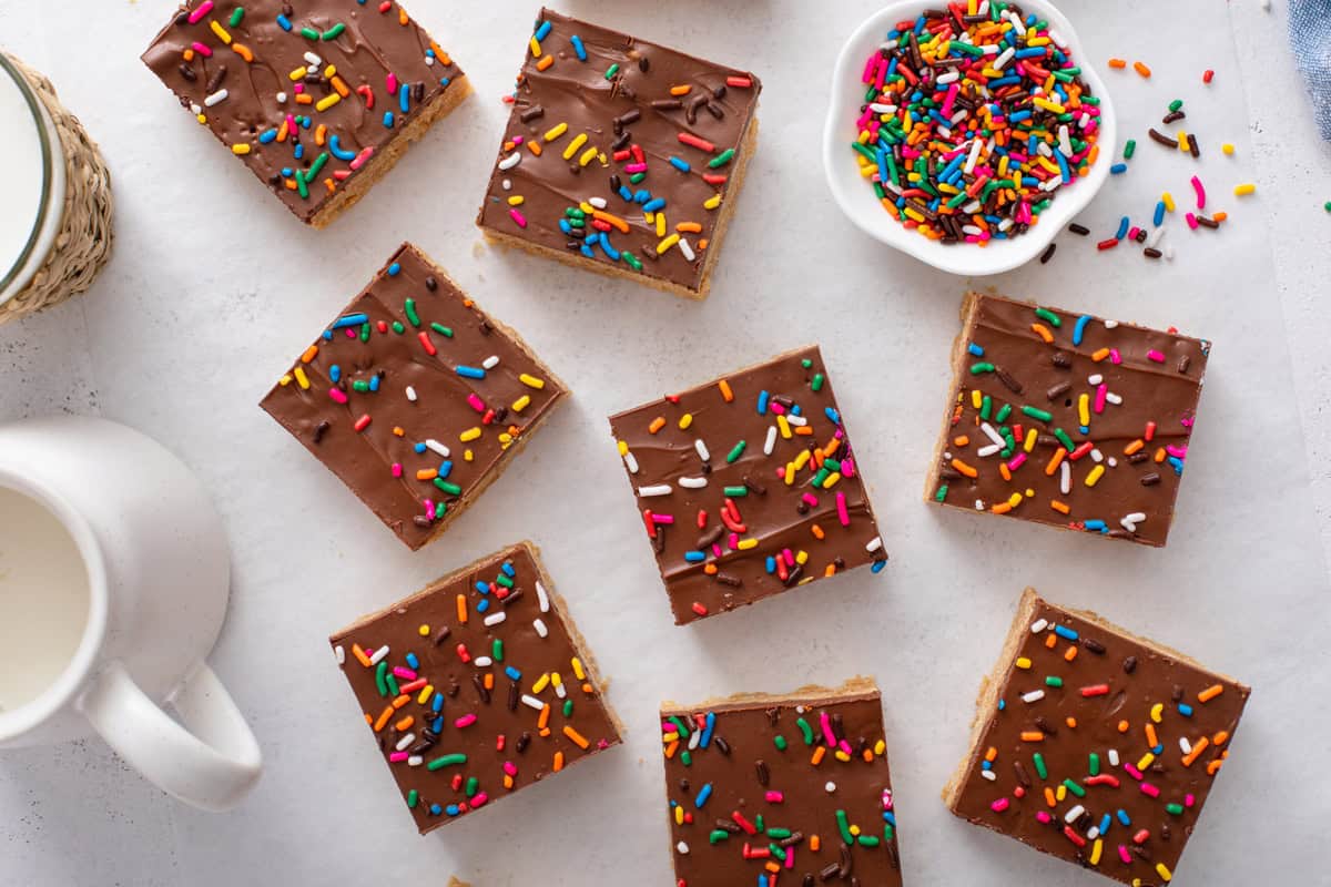 Overhead view of a pan of sprinkle-topped scotcheroos cut into bars on a countertop.