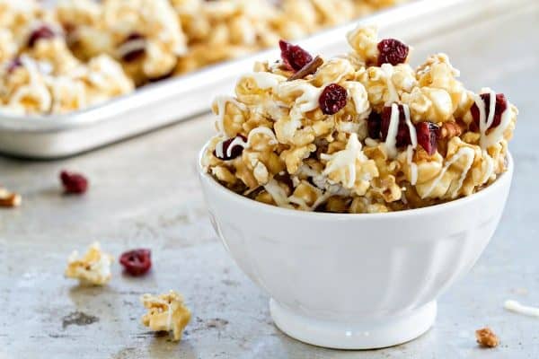 Maple Caramel Corn with marshmallows, chopped pecans, dried cranberries, and a decadent drizzle of white chocolate. THIS is the caramel corn you'll want to make and eat, all fall long.