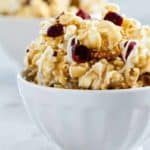 Maple Caramel Corn with marshmallows, chopped pecans, dried cranberries, and a decadent drizzle of white chocolate. THIS is the caramel corn you'll want to make and eat, all fall long.