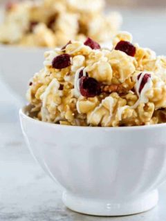 Maple Caramel Corn with marshmallows, chopped pecans, dried cranberries, and a decadent drizzle of white chocolate. THIS is the caramel corn you'll want to make and eat, all fall long.