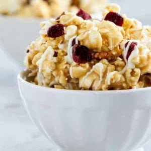 Maple Caramel Corn with marshmallows, chopped pecans, dried cranberries, and a decadent drizzle of white chocolate. THIS is the caramel corn you'll want to make and eat, all fall long.