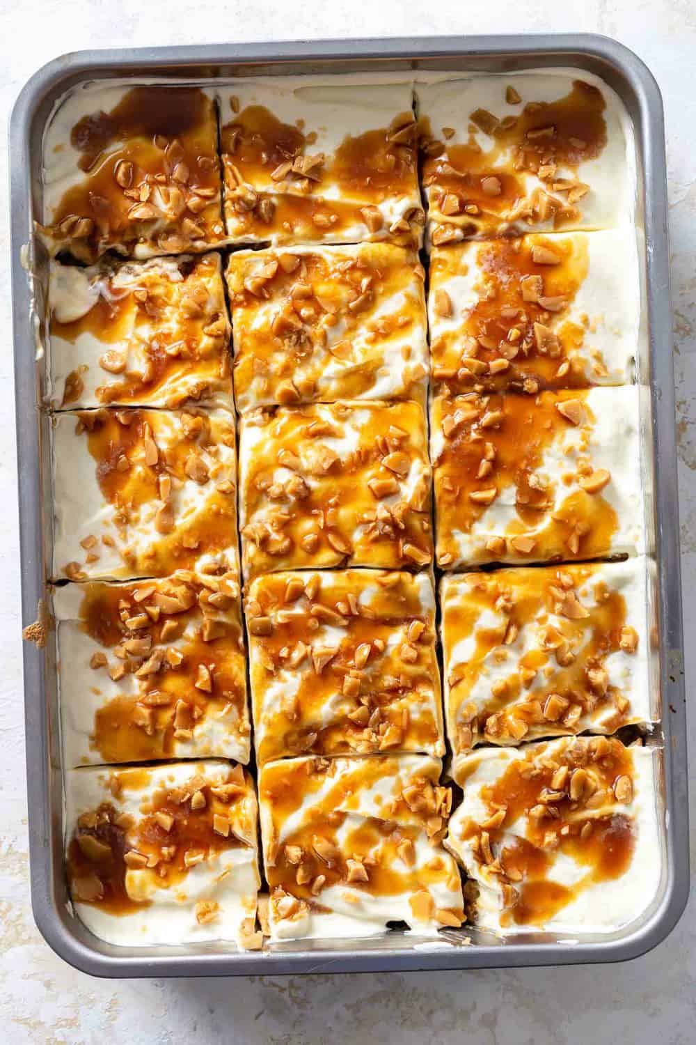 Caramel apple poke cake, sliced in the pan, ready to be served