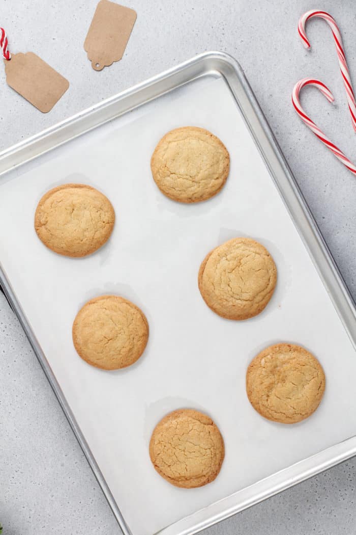 Baked peppermint cookies on a parchment-lined baking sheet.
