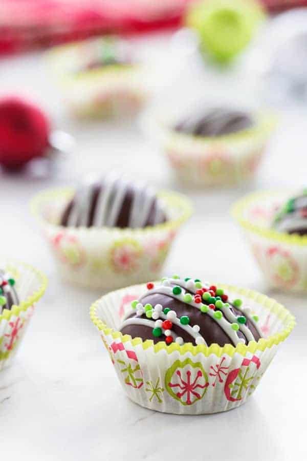 Chocolate Covered Peanut Butter Balls make a festive treat the whole family will love! Holiday sprinkles make them extra festive!