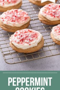 Wire rack filled with peppermint cookies frosted with cream cheese frosting and topped with crushed candy canes. Text overlay includes recipe name.