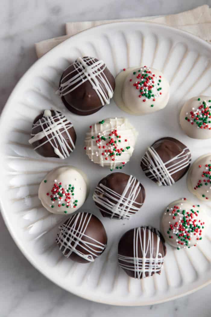 Overhead view of chocolate-covered peanut butter balls dipped in dark chocolate and white chocolate.