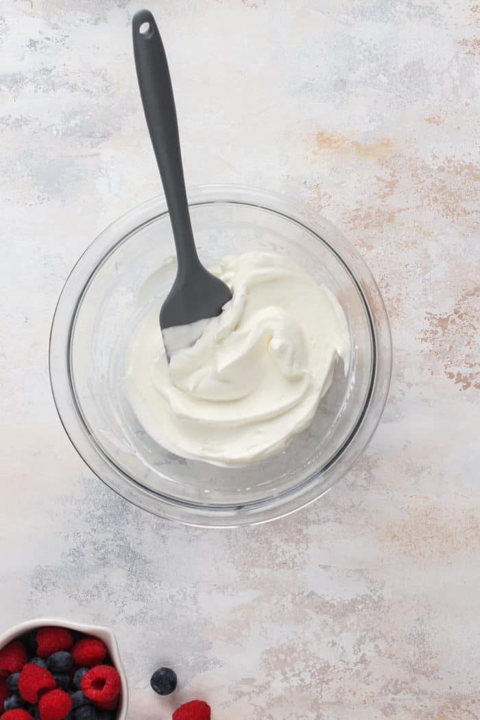 Whipped cream in a glass bowl.