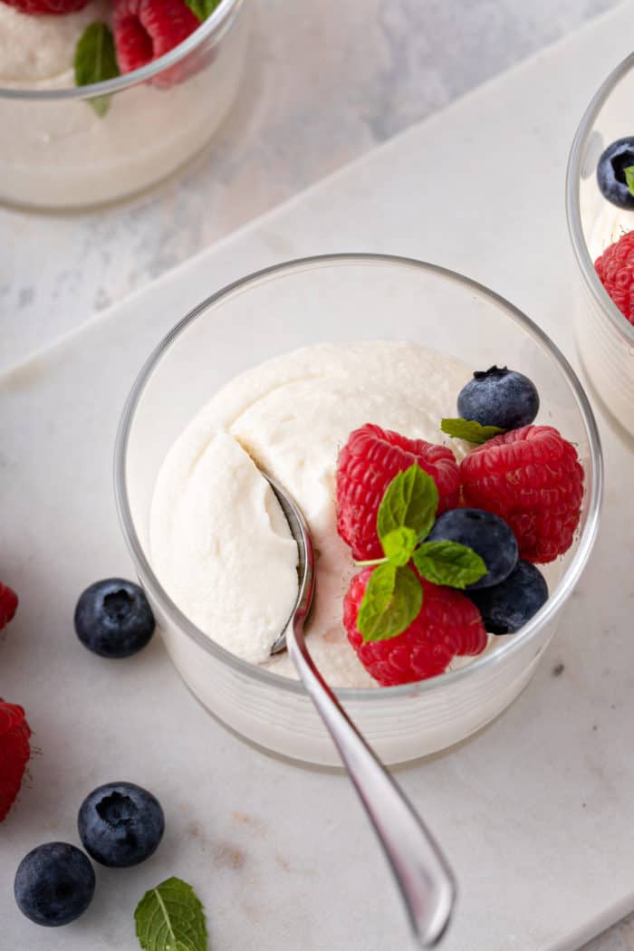 Spoon in a dish of white chocolate mousse.