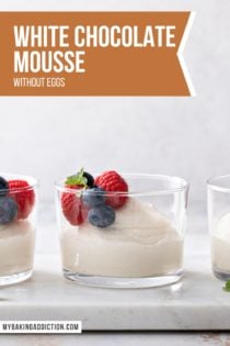 Three glass dishes of white chocolate mousse, topped with berries, lined up on a platter. Text overlay includes recipe name.