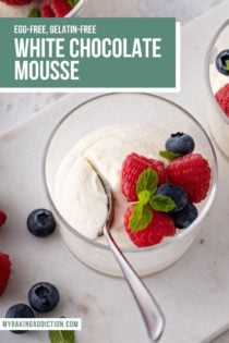 Spoon in a dish of white chocolate mousse. Text overlay includes recipe name.