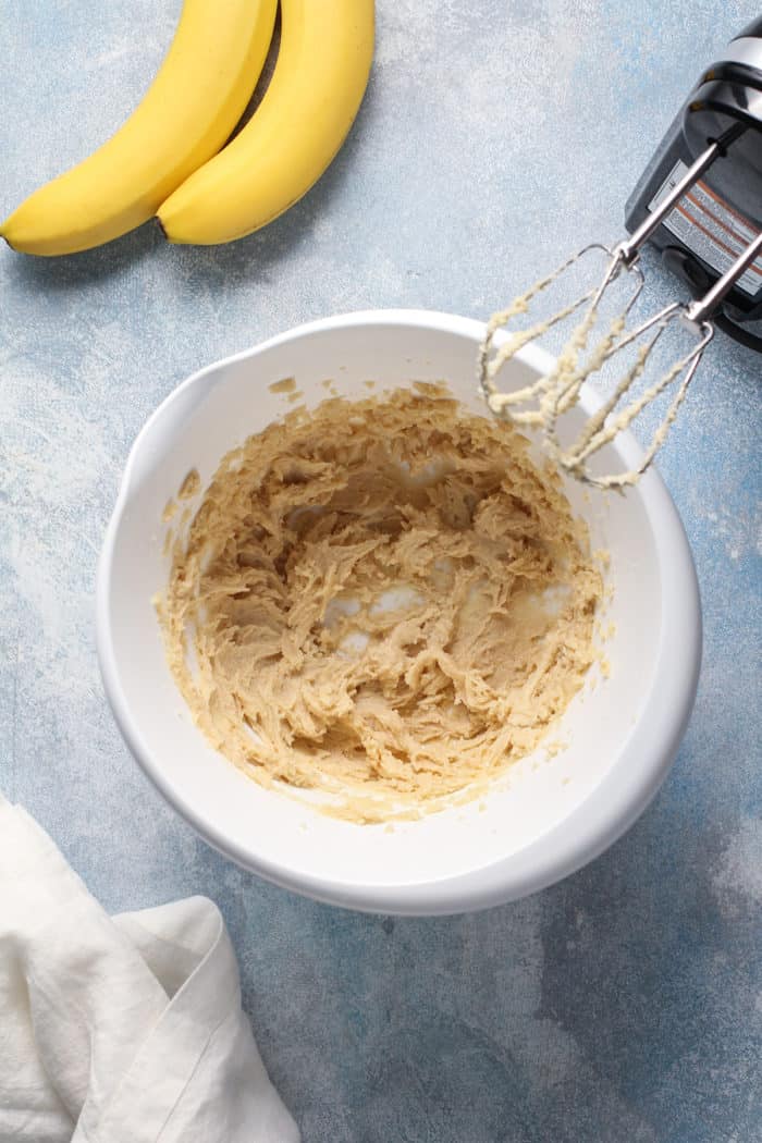 Wet ingredients for cupcakes beaten together in a white mixing bowl