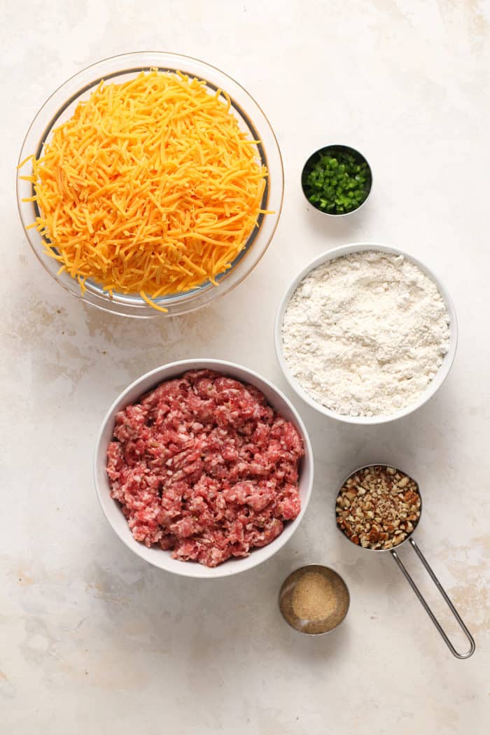 Ingredients for sausage balls arranged on a marble countertop
