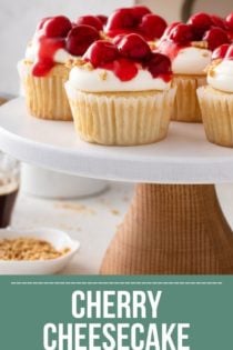 Cherry cheesecake cupcakes on a white cake stand. Text overlay includes recipe name.