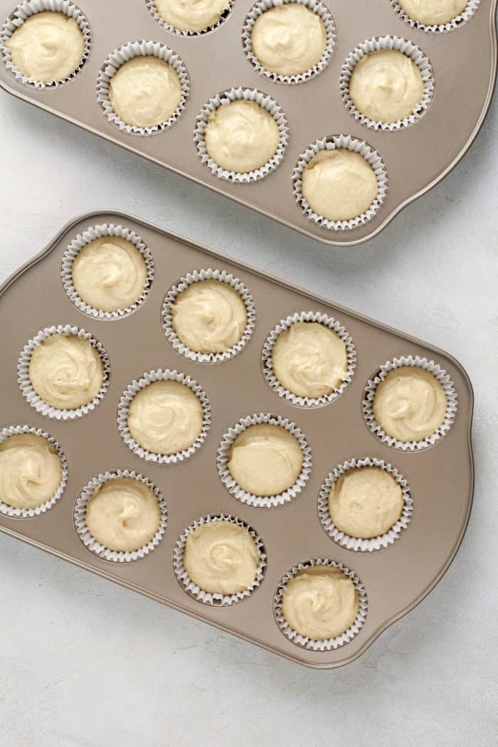 Graham cracker cupcake batter in two muffin tins, ready to go in the oven.