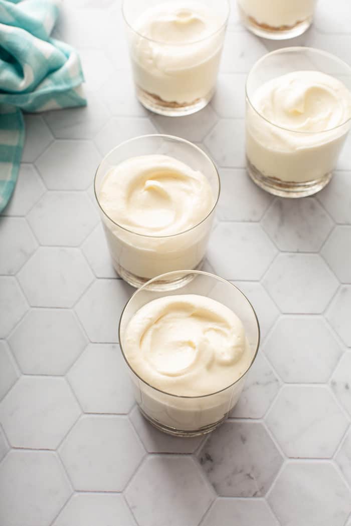 No-bake cheesecakes in individual serving dishes, ready to chill in the refrigerator