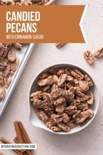 Overhead view of candied pecans in a bowl next to a baking sheet of candied pecans. Text overlay includes recipe name.
