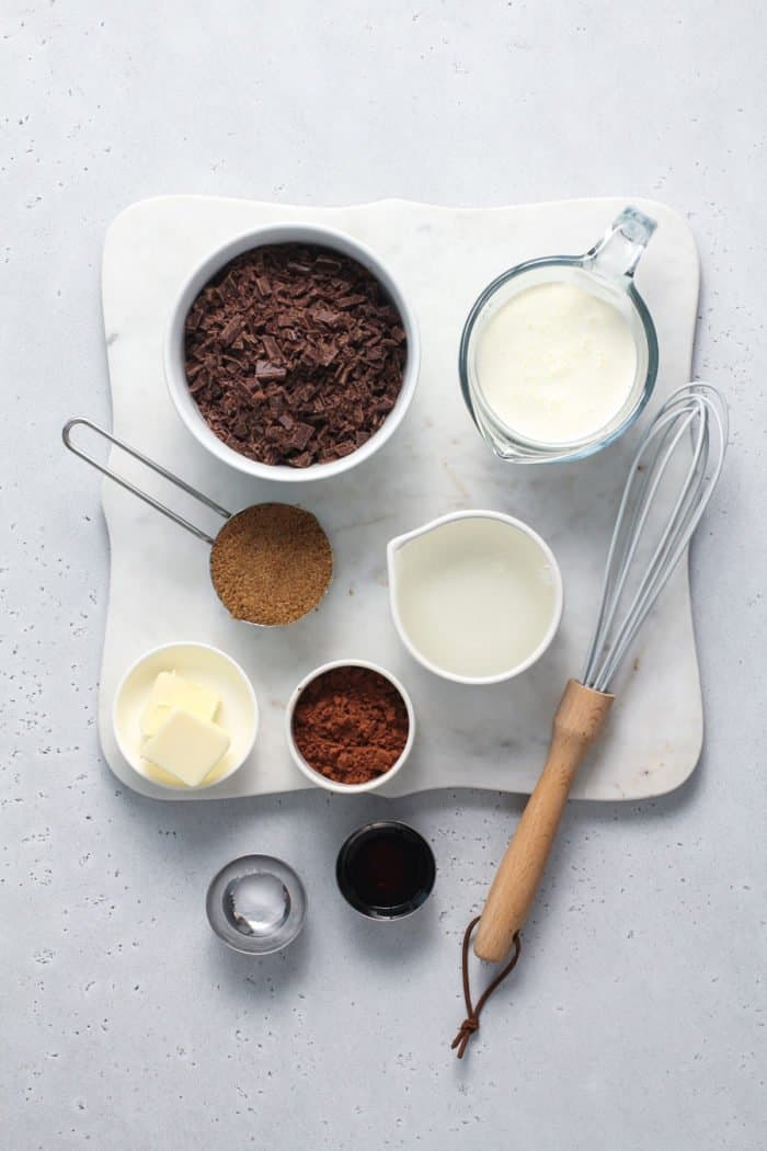 Ingredients for hot fudge sauce arranged on a light gray countertop.