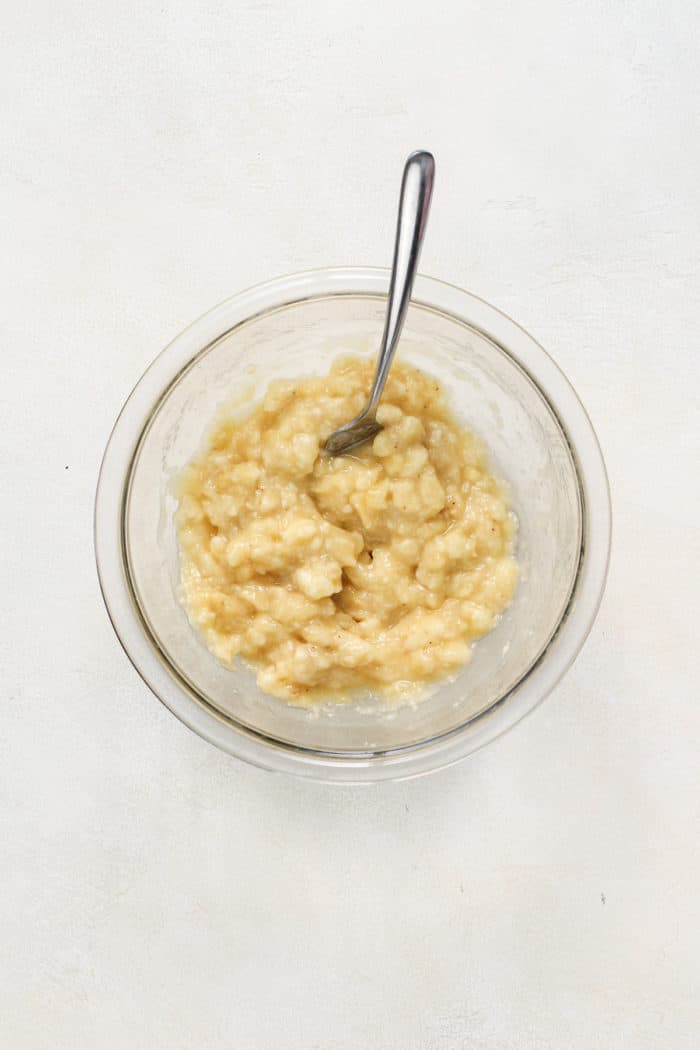 Mashed banana in a glass bowl.