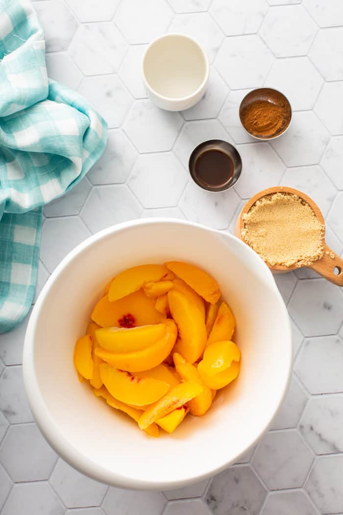 Peach compote ingredients on a white countertop