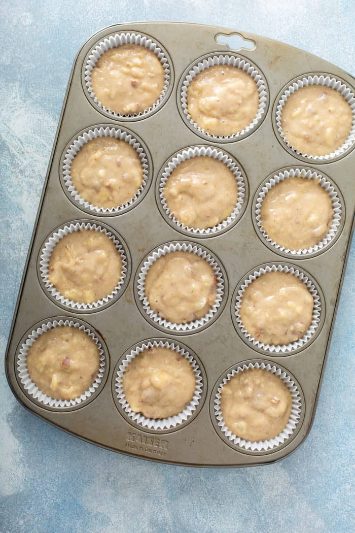 Batter for hummingbird cupcakes in a muffin tin, ready to bake