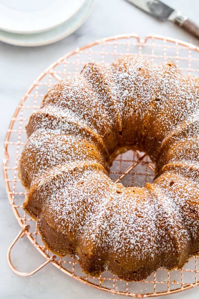 Pound cake lightly dusted with powdered sugar on a cooling rack