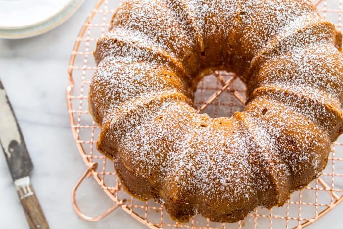 Overhead view of a cream cheese pound cake on a cooling rack