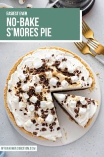 Overhead view of a s'mores pie with a slice cut from it. Text overlay is added for pinterest.