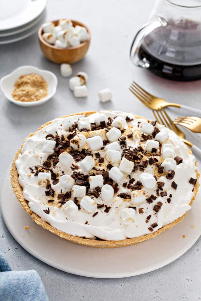 S'mores pie topping with mini marshmallows, chocolate shavings, and graham cracker crumbs.