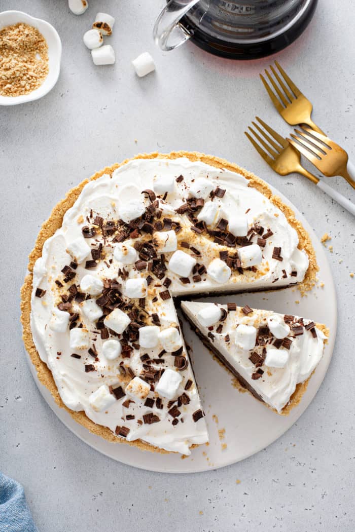 Overhead view of a s'mores pie with a slice cut from it.