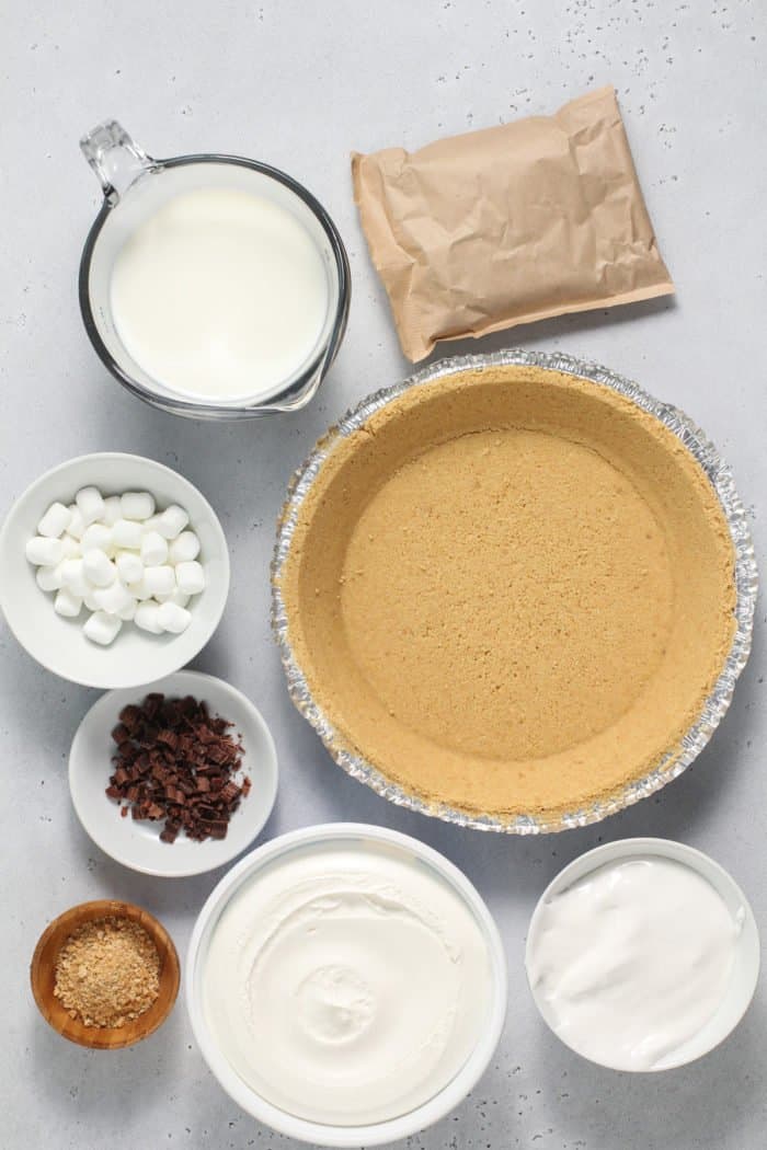 Ingredients for s'mores pie arranged on a gray countertop.