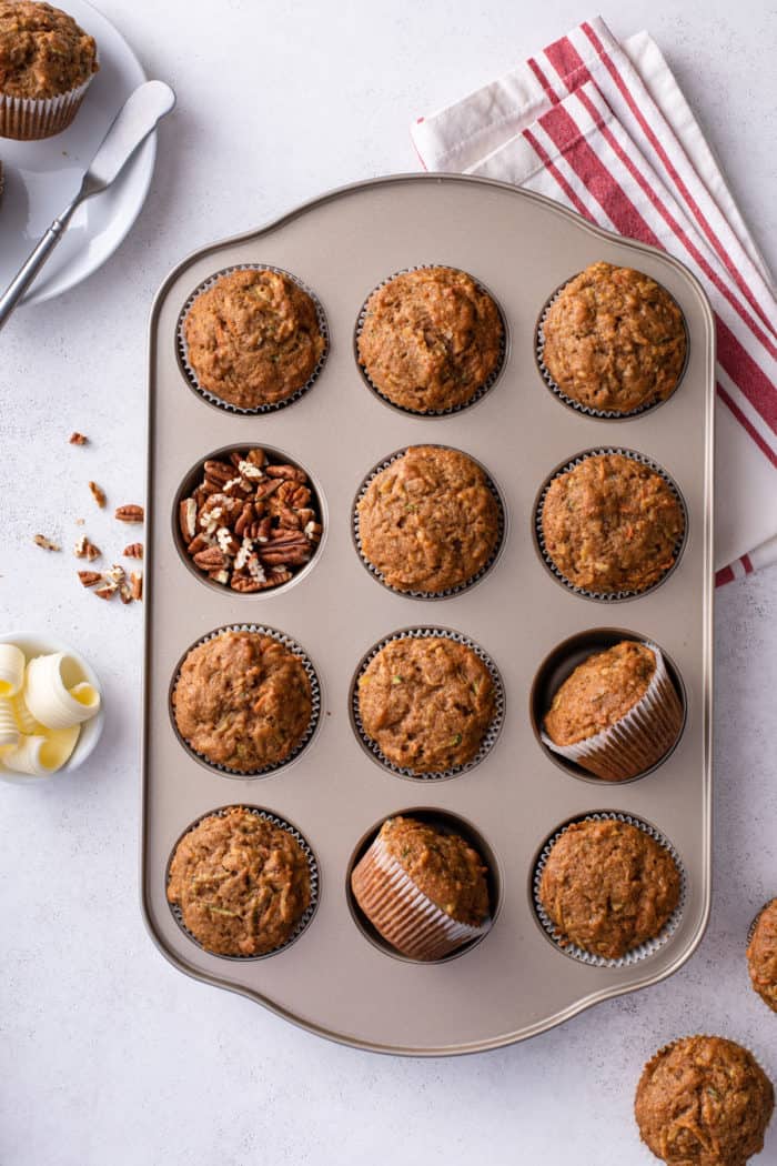 Overhead view of baked morning glory muffins in a muffin tin.